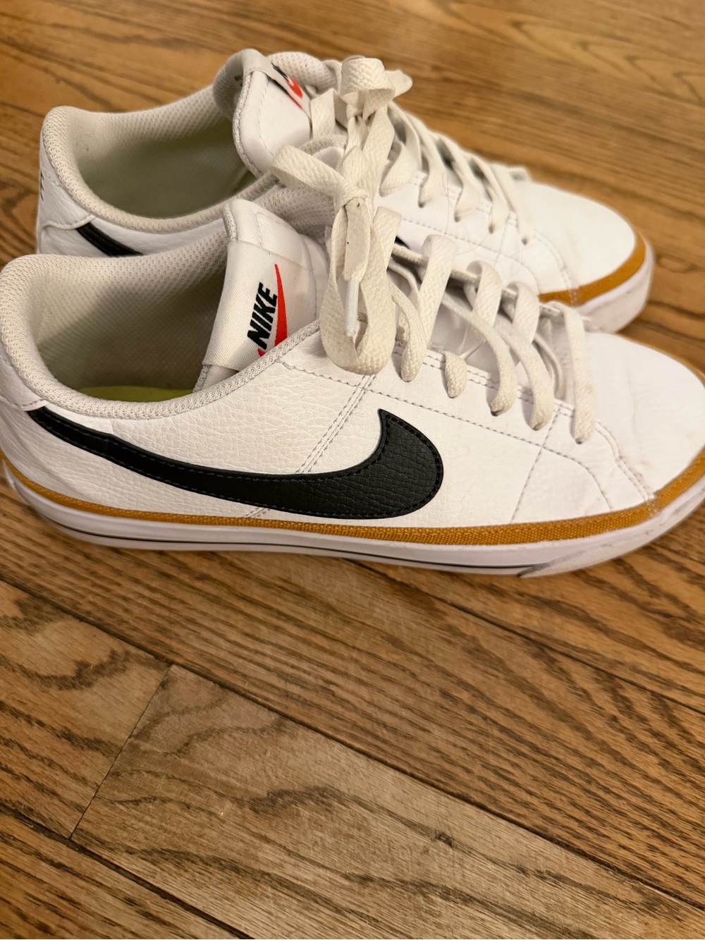Nike White Sneakers with Black Swoosh and Gold Accent - Picture 2 of 5